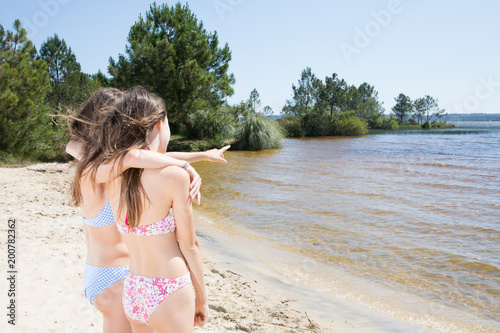 Fototapeta Naklejka Na Ścianę i Meble -  portrait of friends beautiful happy girl on sea and spraying at the beach on beautiful summer