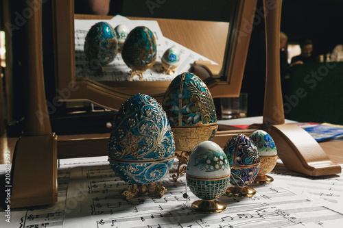 decorative copy Faberge eggs on the notes next to the mirror photo