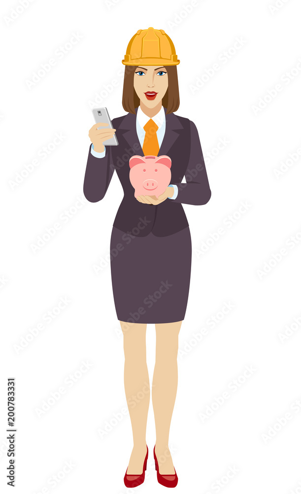Businesswoman in construction helmet using a mobile phone and holding a piggy bank Businesswoman in construction helmet using a mobile phone and holding a piggy bank