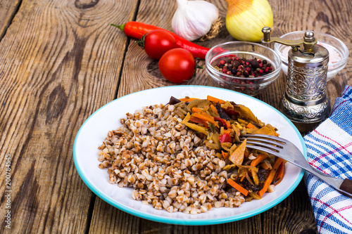 Vegetarian dish. Grain porridge with stewed vegetables