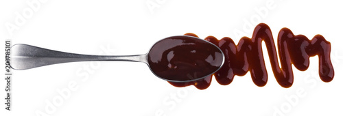 Barbecue sauce. Splashes and spilled grill sauce with spoon isolated on white background. Top view