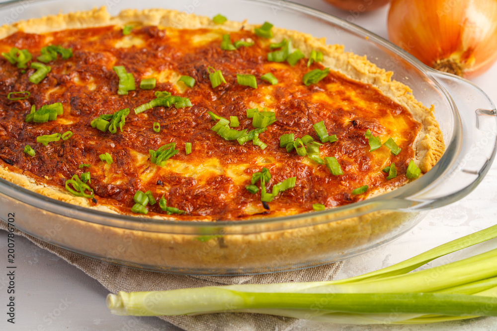 Vegetarian potato pie. Quiche lorraine with potato, cheese and eggs in a glass oven dish.