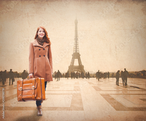 Redhead woman with suitcase come to Paris for conquer © Masson