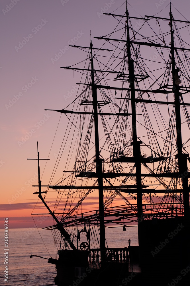 frangat. brigantine.Sailing ship on sunset background