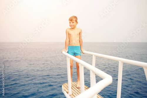 Small boy enjoying summer vacation on sea. Happy boy on yacht cruise. Image with copy space © skumer