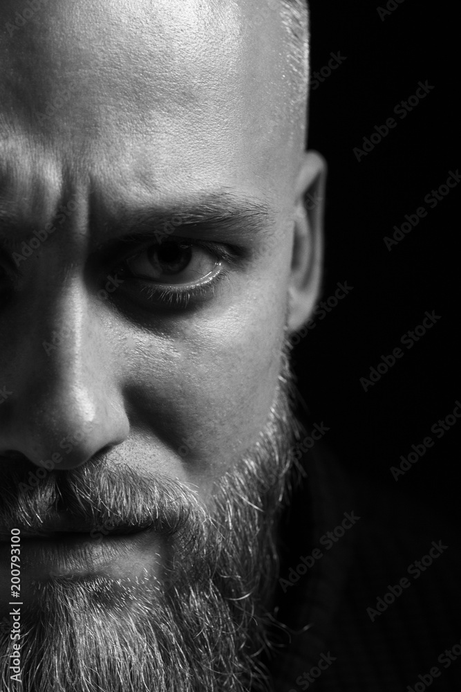 portrait of a brutal man close-up on a black background portrait of a brutal man close-up on a black background
