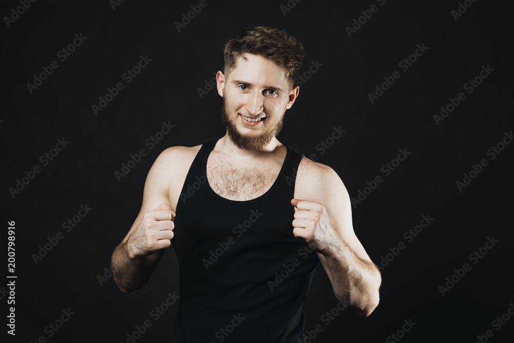 Attractive sportsman looking at camera and smilling while is showing gestures with hands. Attractive sportsman looking at camera and smilling while is showing gestures with hands.