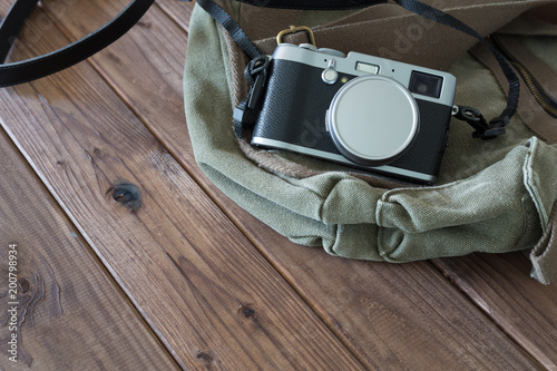 retro photo camera and stylish bag
