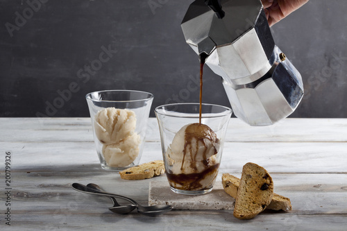 Espresso is pouring into ice cream cup. photo