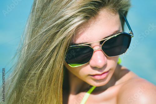 Closeup fashion beautiful woman portrait wearing sunglasses. Portrait of happy teenage girl in sunglasses. Summer lady