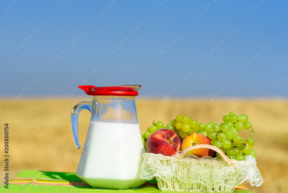 First fruits habikkurim in hebrew and milk on rustic green towel