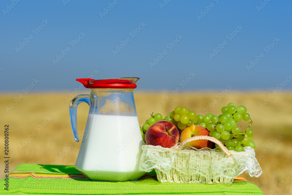 First fruits habikkurim in hebrew and milk on rustic green towel