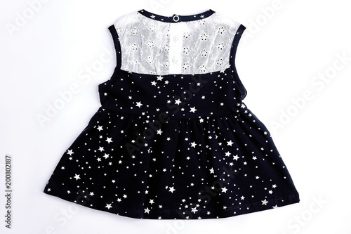 Baby-girl white and black dress. Cotton sleeveless embroidered summer dress for infant girl, isolated on white background. Baby-girl black patterned dress.