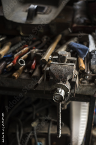 Dirty set of hand tools on a wooden panel © librakv