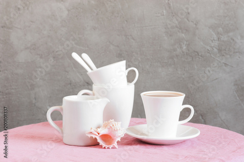 Life stile with white crockery for tea or coffee and shell
