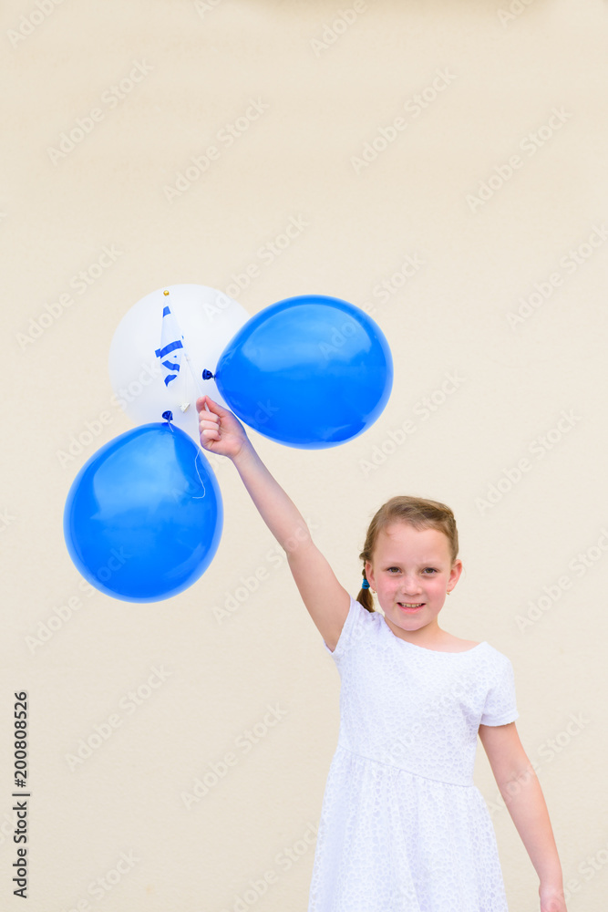 Happy kid, cute little caucasian girl (age 8-9) with blue and white balloons and Israel flag.Patriotic holiday Independence day Israel - Yom Ha'atzmaut concept. Happy kid, cute little caucasian girl (age 8-9) with blue and white balloons and Israel flag.Patriotic holiday Independence day Israel - Yom Ha'atzmaut concept.