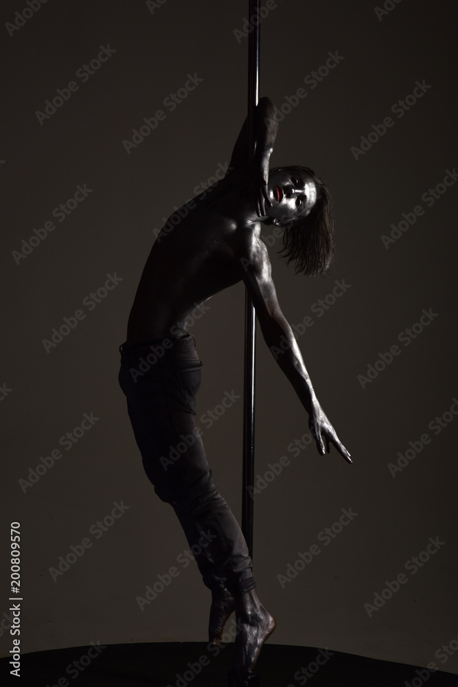 Performance concept. Guy hanging on metallis pole. Performance concept. Guy hanging on metallis pole.