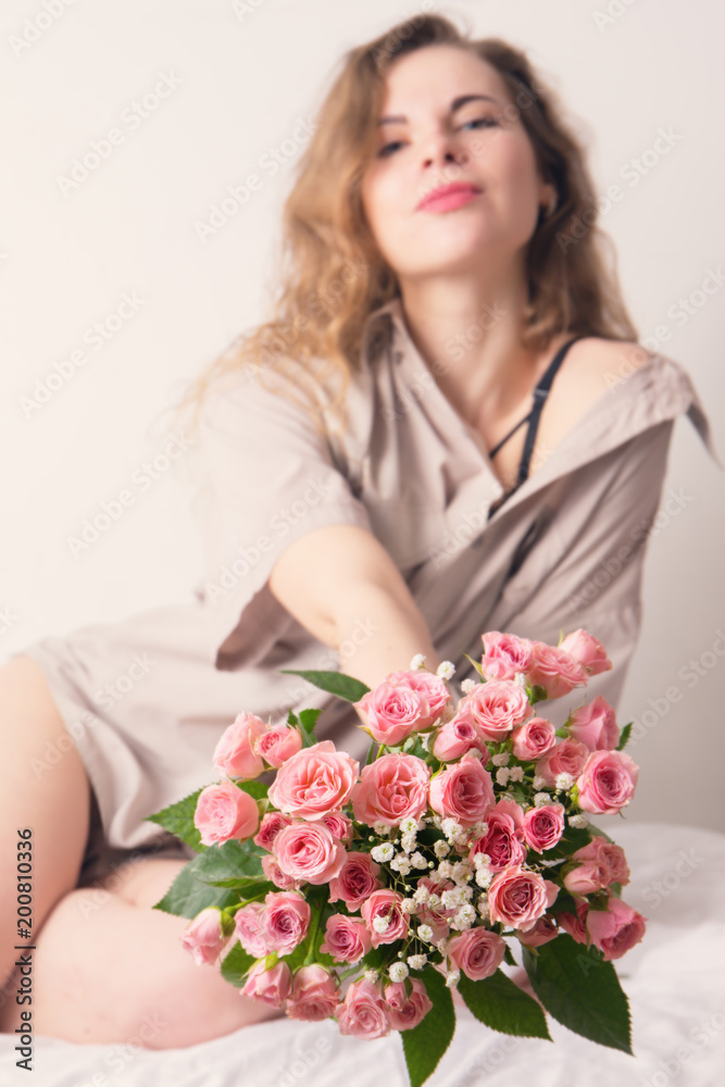 Woman holds out a bouquet Woman holds out a bouquet