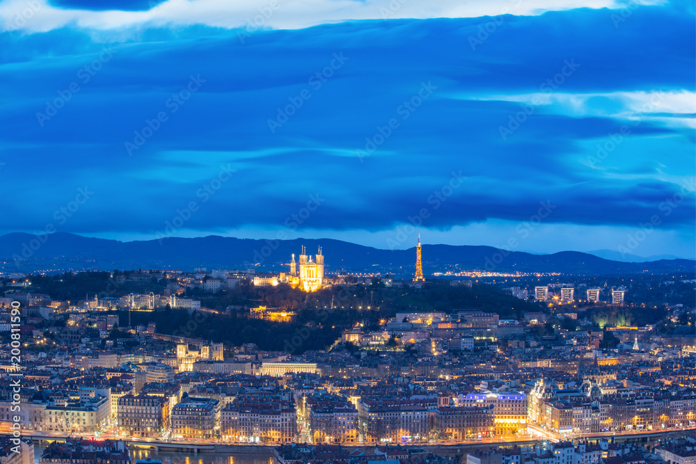 Aerial view of Old town with Fourviere cathedral during evening blue hour in Lyon, France