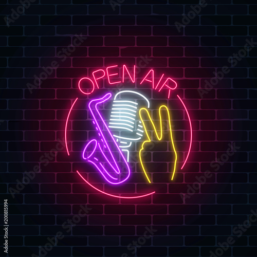 Neon open air sign with microphone, saxophone and piece gesture in round frame. Live music in open air icon.