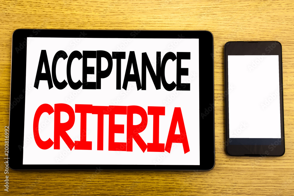 Writing text showing Acceptance Criteria. Business concept for Digital Criterion Written on tablet laptop, wooden background with sticky note, coffee and pen Writing text showing Acceptance Criteria. Business concept for Digital Criterion Written on tablet laptop, wooden background with sticky note, coffee and pen