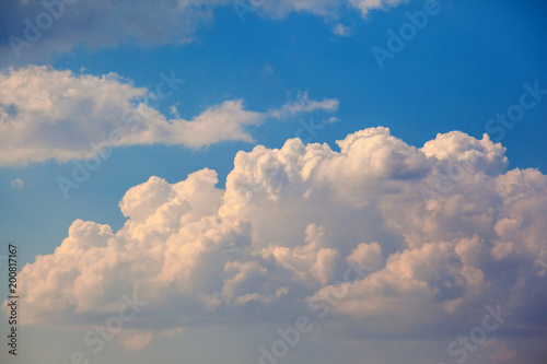 Big white cumulus cloud against blue sky