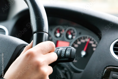 Woman's hand on steering wheel