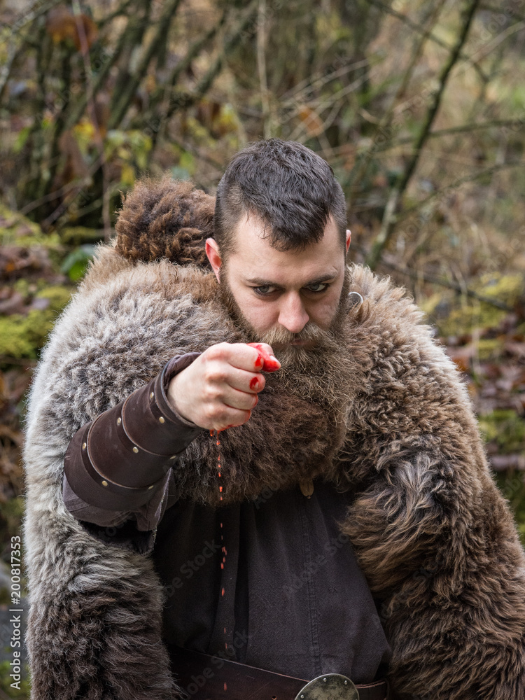 an ancient Viking warrior clenches the fist of his bloody hand an ancient Viking warrior clenches the fist of his bloody hand