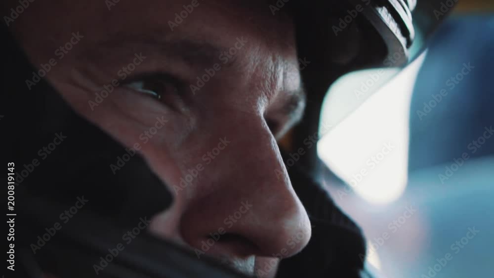 the racer in the helmet looks into the distance