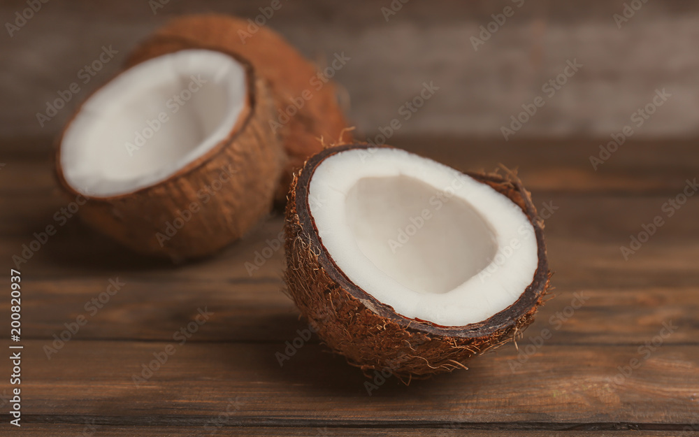 Fresh yummy coconuts on wooden table Fresh yummy coconuts on wooden table