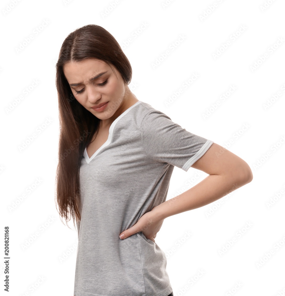 Young woman suffering from back pain on white background Young woman suffering from back pain on white background