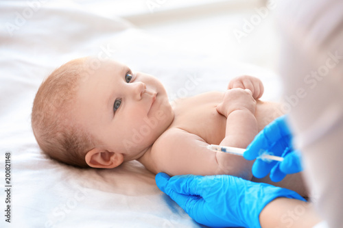 Doctor vaccinating baby in clinic