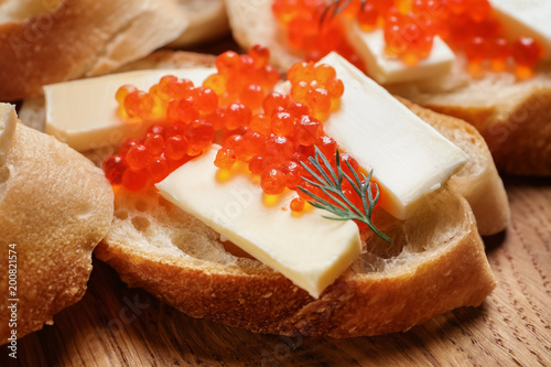 Delicious sandwich with red caviar, closeup