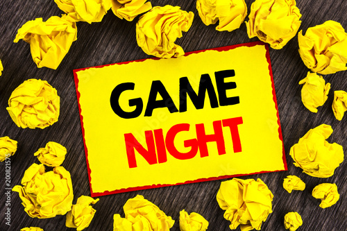 Handwriting Announcement text  Game Night. Conceptual photo Entertainment Fun Play Time Event For Gaming written on Yellow Stikcy Note Folded Paper on the wooden background photo