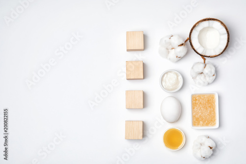 Cubes with word "Acne" and homemade problem skin remedy ingredients on white background