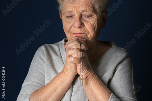 Religious elderly woman pra...