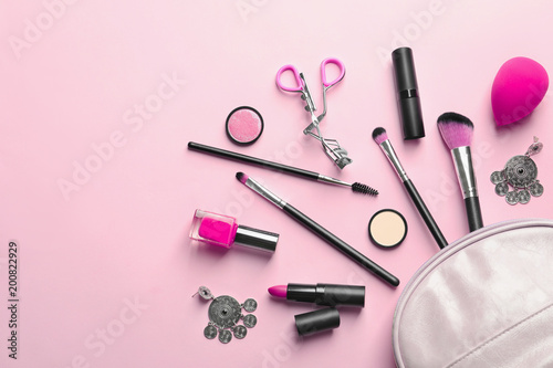 Fototapeta Naklejka Na Ścianę i Meble -  Makeup products with cosmetic bag on color background