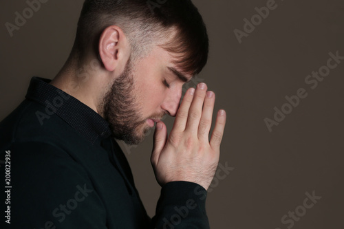 Religious young man praying...