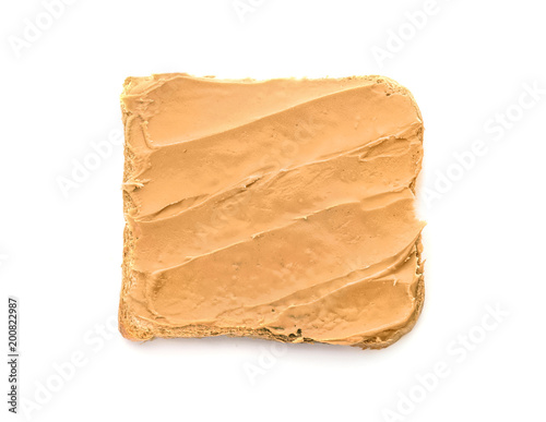 Tasty toast with peanut butter on white background
