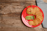 Funny pancakes for kids breakfast on wooden table, top view