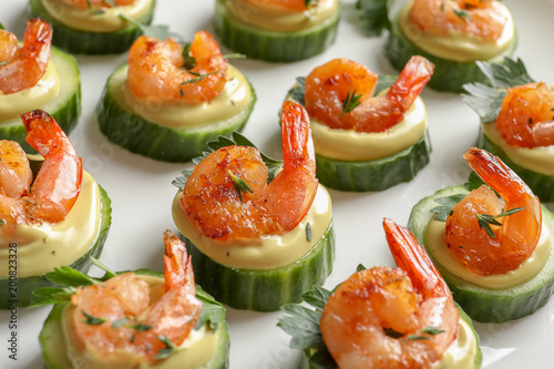 Delicious snacks with shrimp on plate