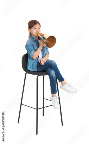 Adorable little girl with vintage megaphone on white background