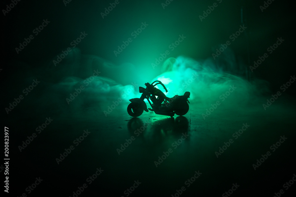 High power motorcycle chopper. Fog with backlights on background with man rider at night. Empty space