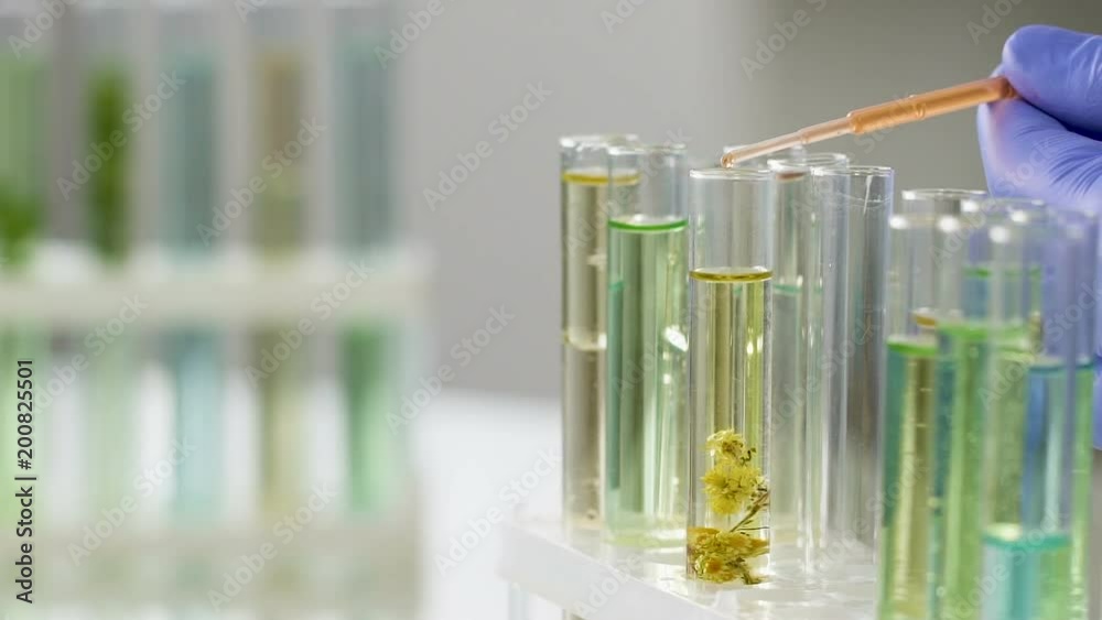 Scientist mixing different fluids to obtain active medication, slow-motion