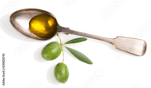 Olive oil and twig with olives.