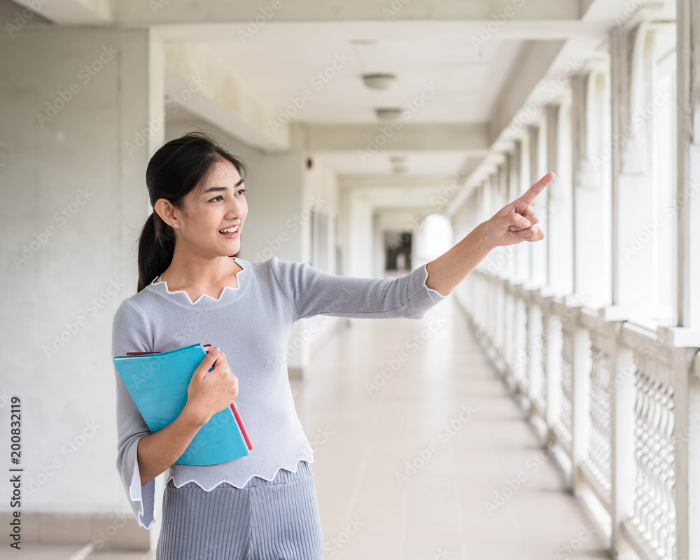 Portrait of a young student holding the book - Back to school. Portrait of a young student holding the book - Back to school.