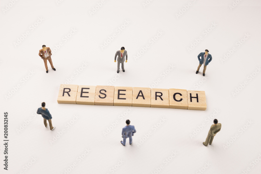 businessman figures meeting on research word