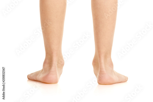 Closeup of little male flatfoot legs isolated on white background photo
