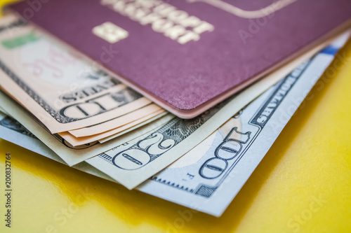 dollars in red passport on yellow paper background
