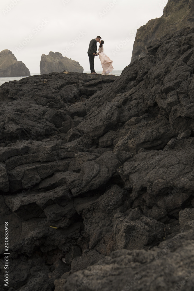 Bride and groom kiss at top rocky mountan Bride and groom kiss at top rocky mountan